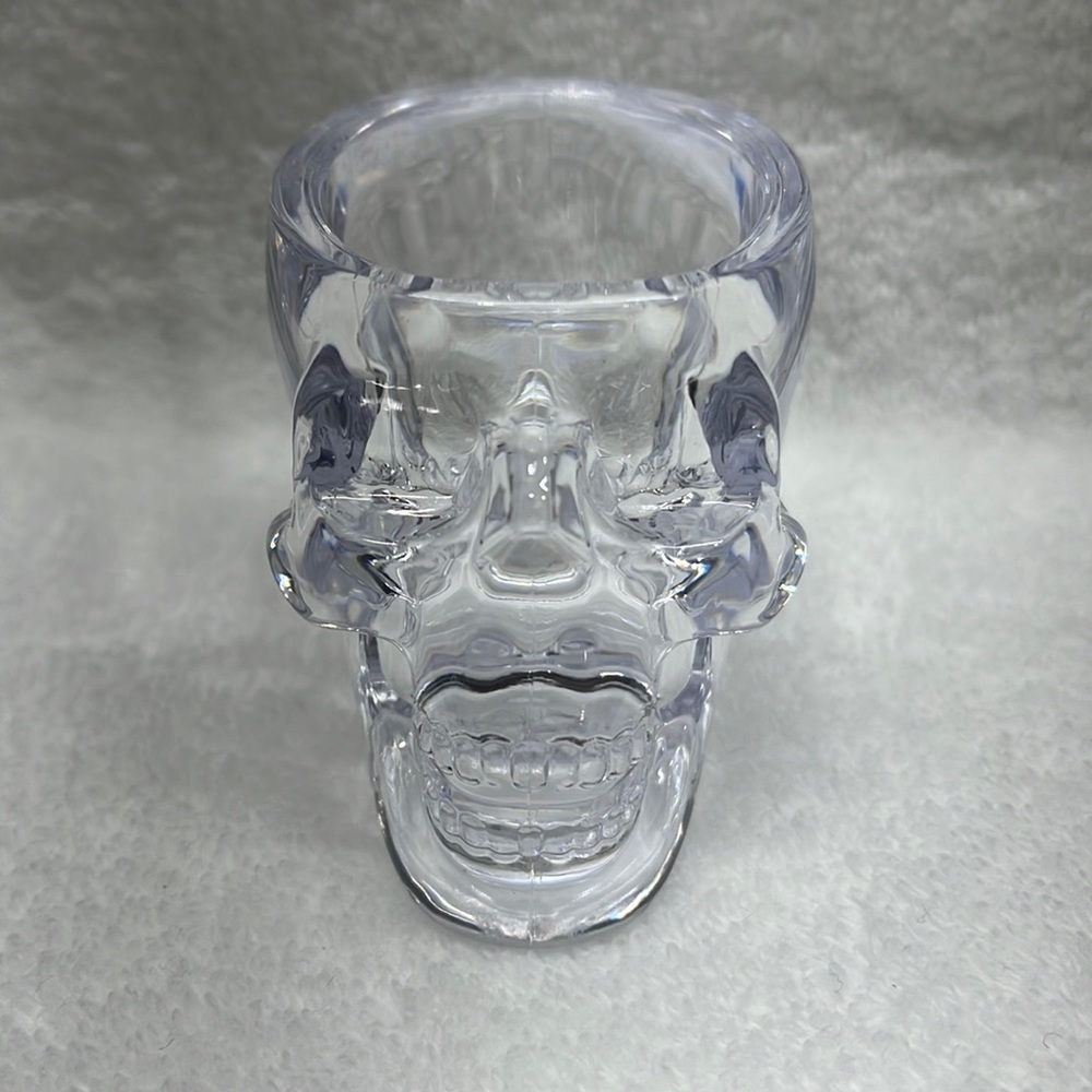 Set of 4 skull shot glasses .